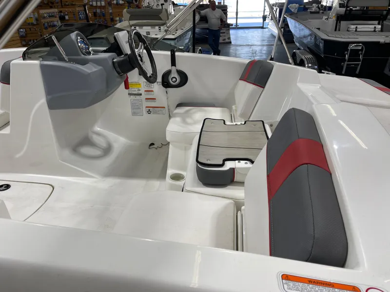 Slide: The Image of 2020 Tahoe T16 boat interior with steering wheel, seating, and dashboard in showroom. - 10