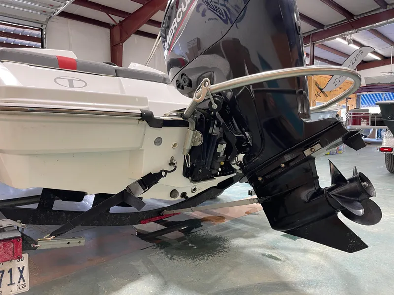 Slide: The Image of 2020 Tahoe T16 boat with Mercury outboard motor in a garage setting. - 13