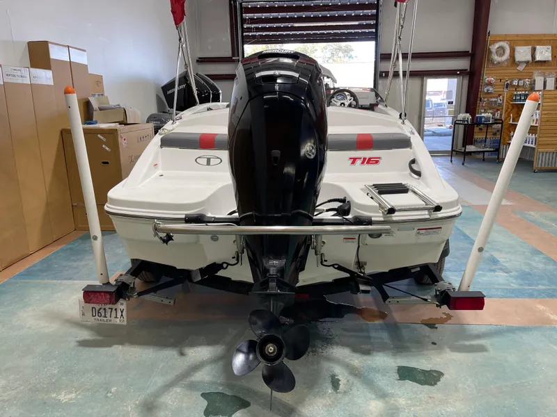 Slide: The Image of 2020 Tahoe T16 boat in a garage, rear view with outboard motor. - 14