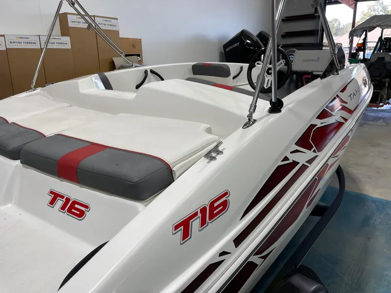 Slide: The Image of 2020 Tahoe T16 boat with red accents, displayed indoors. - 15