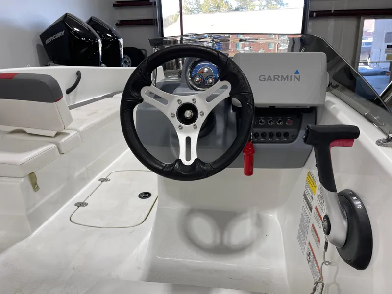 Slide: The Image of 2020 Tahoe T16 boat cockpit with Garmin navigation and Mercury engines in background. - 16