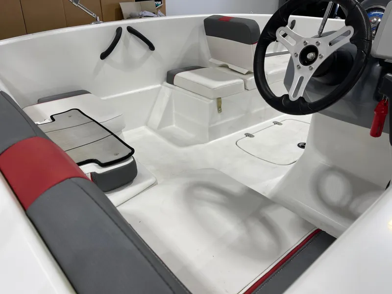 Slide: The Image of Interior of a 2020 Tahoe T16 boat, featuring seating and steering wheel. - 19