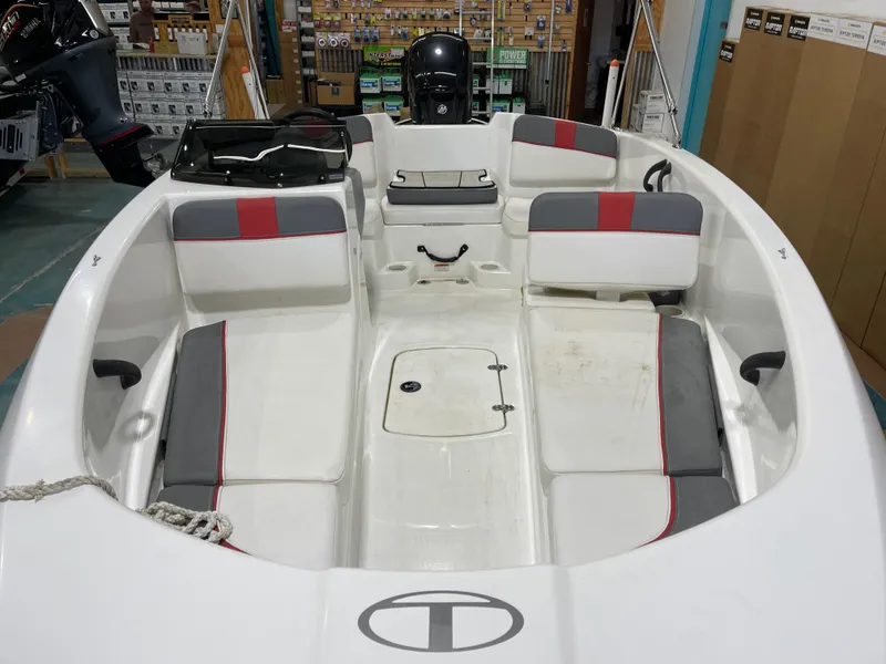 Slide: The Image of 2020 Tahoe T16 boat interior with white and red seating, displayed indoors. - 20