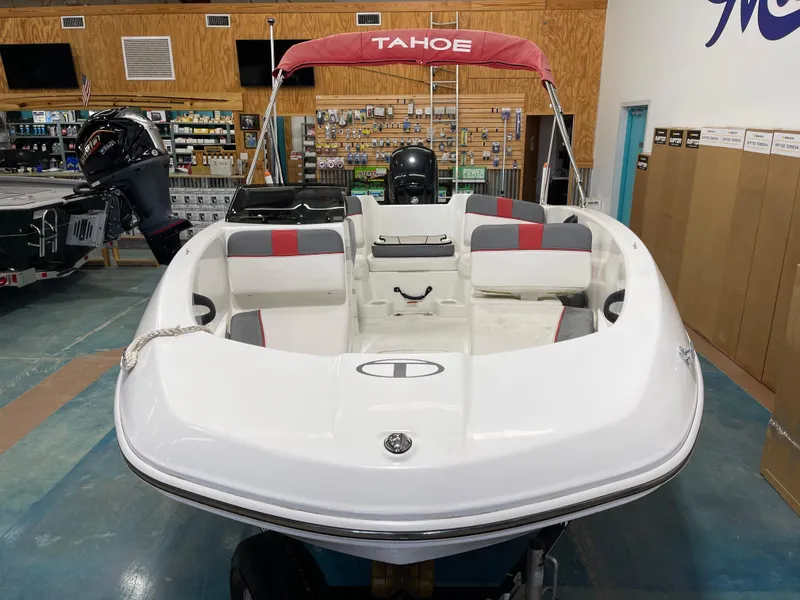 Slide: The Image of 2020 Tahoe T16 boat with red canopy displayed indoors. - 7