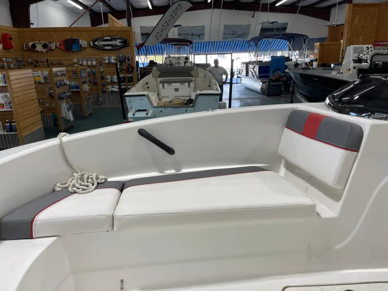 Slide: The Image of Interior of a 2020 Tahoe T16 boat with cushioned seating in a showroom. - 9