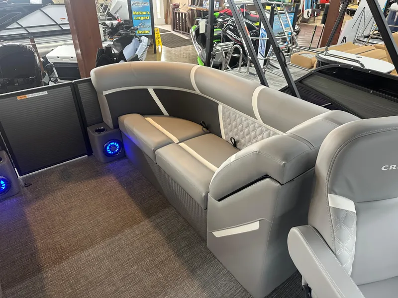 Slide: The Image of 2025 Crest Classic 220 boat interior with gray seating and blue LED lights. - 11