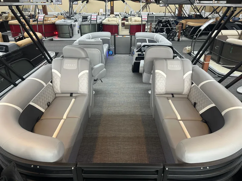 Slide: The Image of 2025 Crest Classic 220 pontoon boat interior with luxurious gray seating and spacious layout. - 13