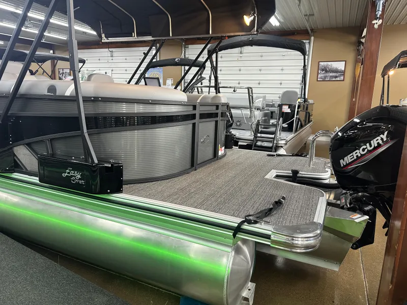 Slide: The Image of 2025 Crest Classic 220 pontoon boat with Mercury engine in showroom. - 14