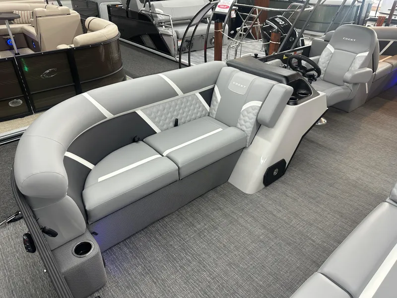 Slide: The Image of 2025 Crest Classic 220 pontoon boat interior with gray seating and modern helm. - 4