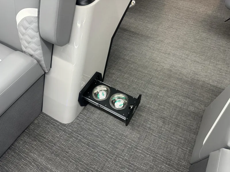 Slide: The Image of 2025 Crest Classic 220 interior with retractable cup holders and gray seating. - 6