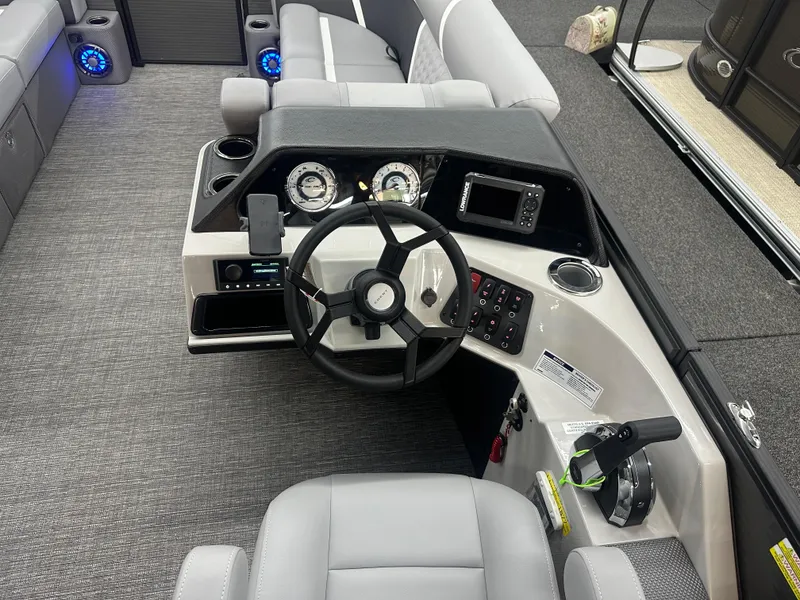 Slide: The Image of 2025 Crest Classic 220 boat interior with modern steering console and seating. - 8