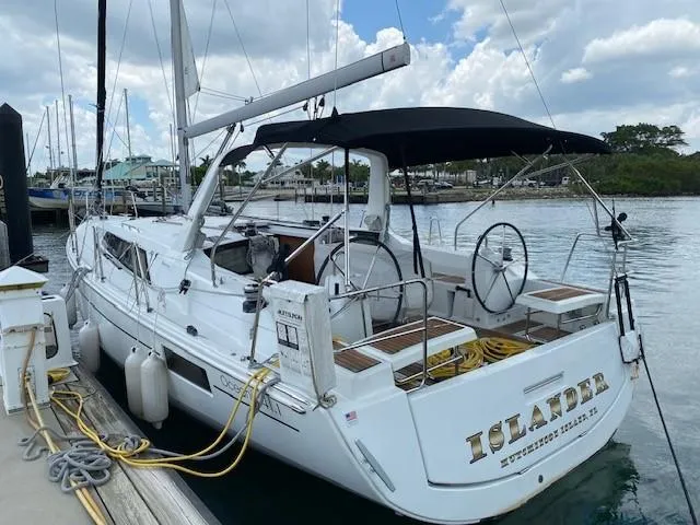 Slide: The Image of 2018 Beneteau Oceanis 41.1 sailboat docked, featuring dual steering wheels and a black canopy. - 0
