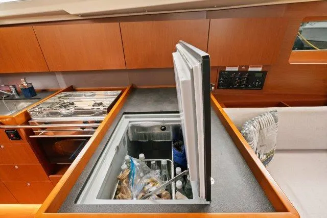Slide: The Image of Interior of 2018 Beneteau Oceanis 41.1 yacht showing galley with open fridge. - 13