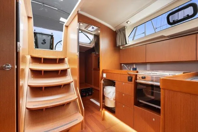 Slide: The Image of Interior of 2018 Beneteau Oceanis 41.1 yacht with wooden cabinetry and modern kitchen. - 14