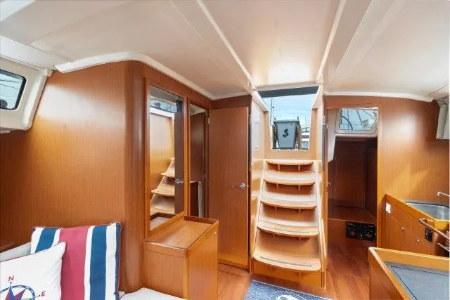 Slide: The Image of Interior of 2018 Beneteau Oceanis 41.1 yacht, featuring wooden cabinetry and modern design. - 16