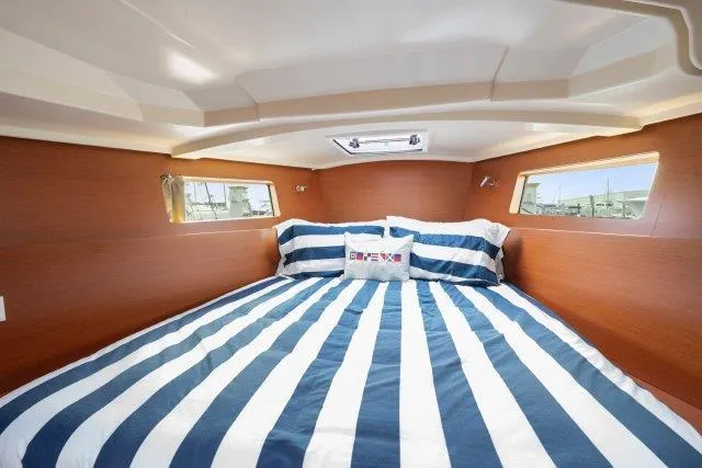 Slide: The Image of Cozy cabin interior of 2018 Beneteau Oceanis 41.1 with striped bedding. - 17