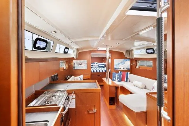 Slide: The Image of Interior of 2018 Beneteau Oceanis 41.1 yacht, featuring modern kitchen and cozy seating area. - 2