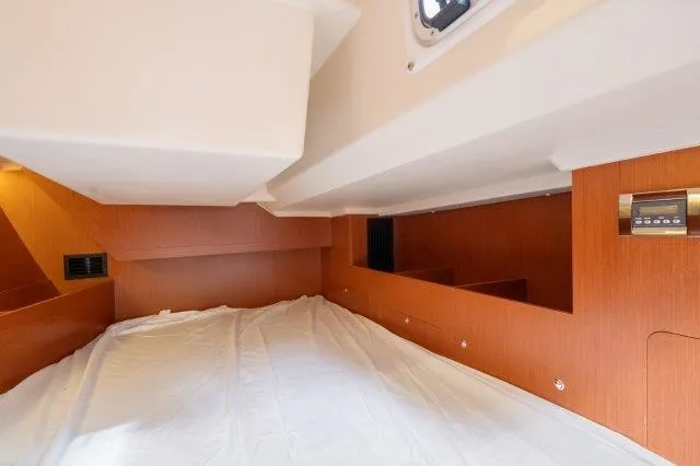 Slide: The Image of Interior cabin of 2018 Beneteau Oceanis 41.1 yacht, featuring wood paneling and a cozy sleeping area. - 21