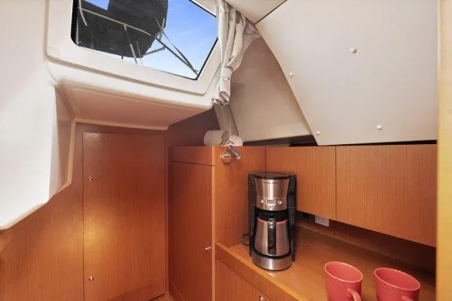 Slide: The Image of Interior of 2018 Beneteau Oceanis 41.1 yacht with coffee maker and red mugs. - 23