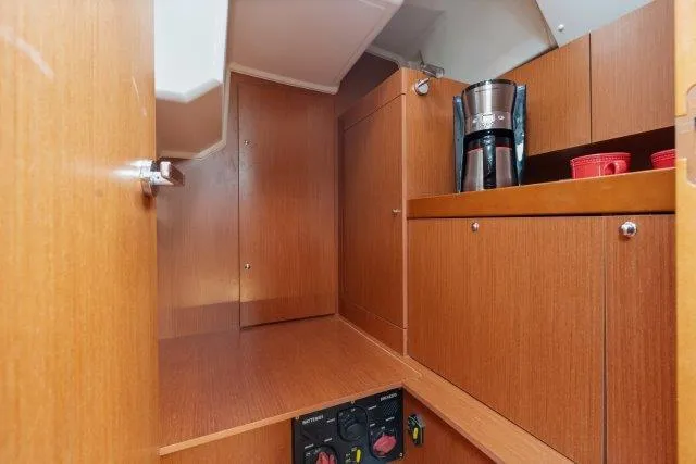 Slide: The Image of Interior of 2018 Beneteau Oceanis 41.1 yacht with wooden cabinetry and coffee maker. - 24