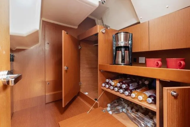 Slide: The Image of Interior of 2018 Beneteau Oceanis 41.1 yacht with storage and coffee maker. - 25