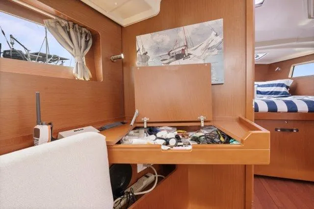 Slide: The Image of Interior of 2018 Beneteau Oceanis 41.1 yacht with wooden cabinetry and nautical decor. - 27
