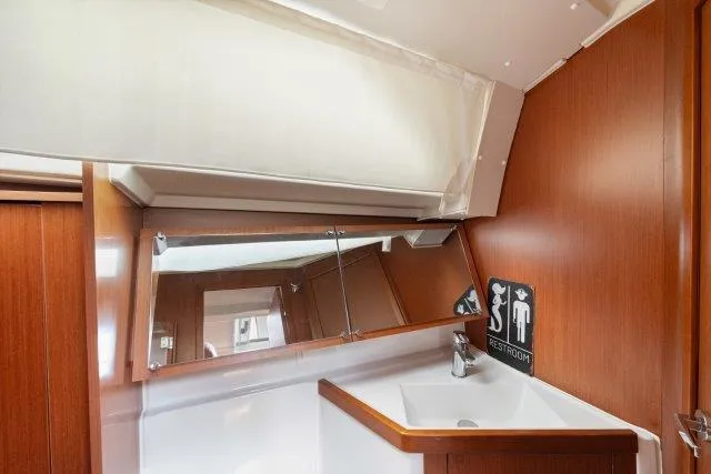 Slide: The Image of Beneteau Oceanis 41.1 2018 yacht bathroom with wooden finish and mirror. - 28