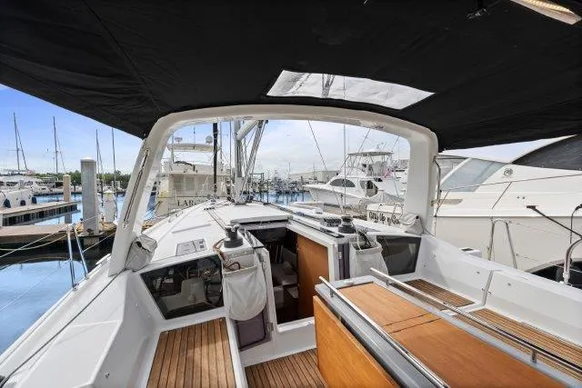 Slide: The Image of 2018 Beneteau Oceanis 41.1 yacht cockpit with wooden deck and marina view. - 34