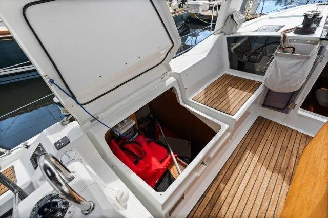 Slide: The Image of 2018 Beneteau Oceanis 41.1 yacht cockpit with open storage compartment and teak flooring. - 35
