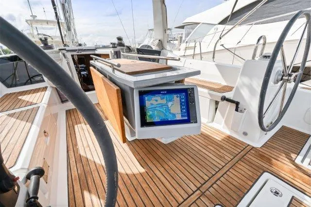 Slide: The Image of 2018 Beneteau Oceanis 41.1 yacht cockpit with navigation display and wooden deck. - 39