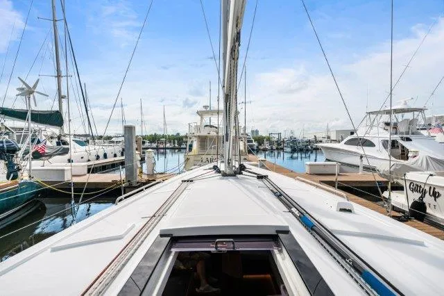 Slide: The Image of 2018 Beneteau Oceanis 41.1 sailboat docked at marina, clear sky, calm waters. - 42
