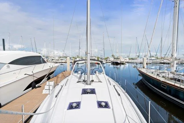 Slide: The Image of 2018 Beneteau Oceanis 41.1 yacht docked in a marina, surrounded by other boats. - 46