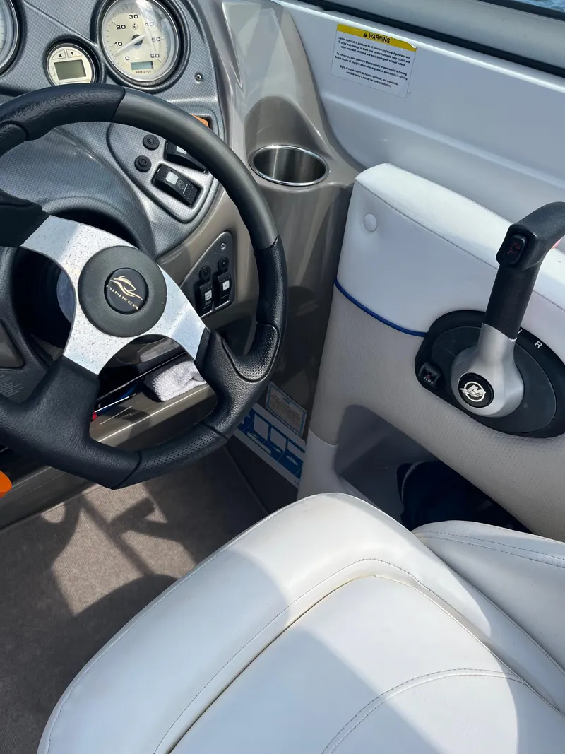 Slide: The Image of 2008 Rinker 246 Captiva Bowrider cockpit with steering wheel and controls. - 11