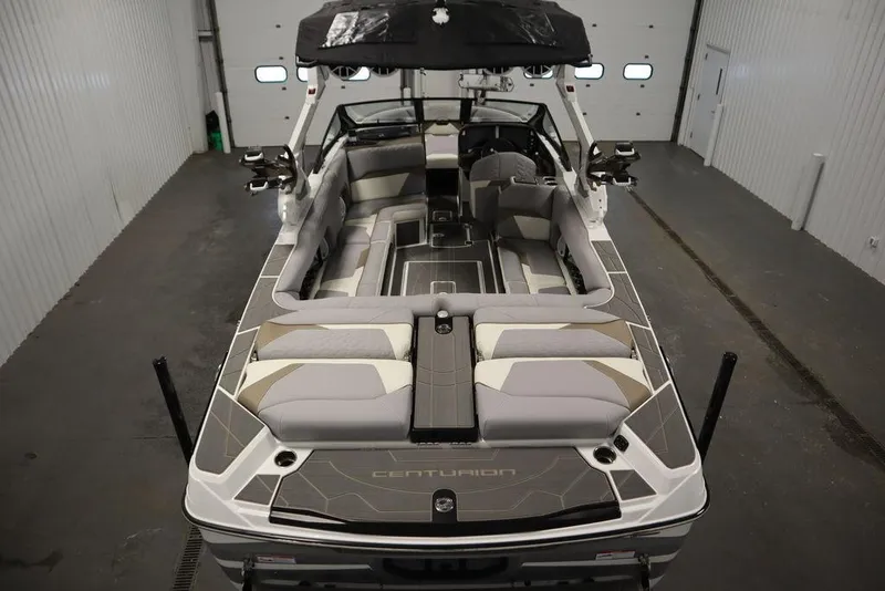Slide: The Image of 2025 Centurion Ri245 boat interior with sleek seating and modern design in a garage setting. - 10