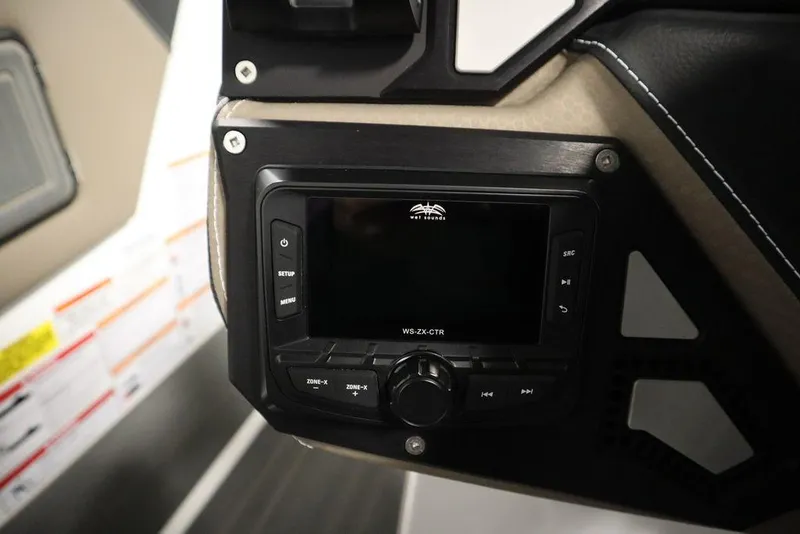 Slide: The Image of 2025 Centurion Ri245 boat dashboard with control panel and display screen. - 20