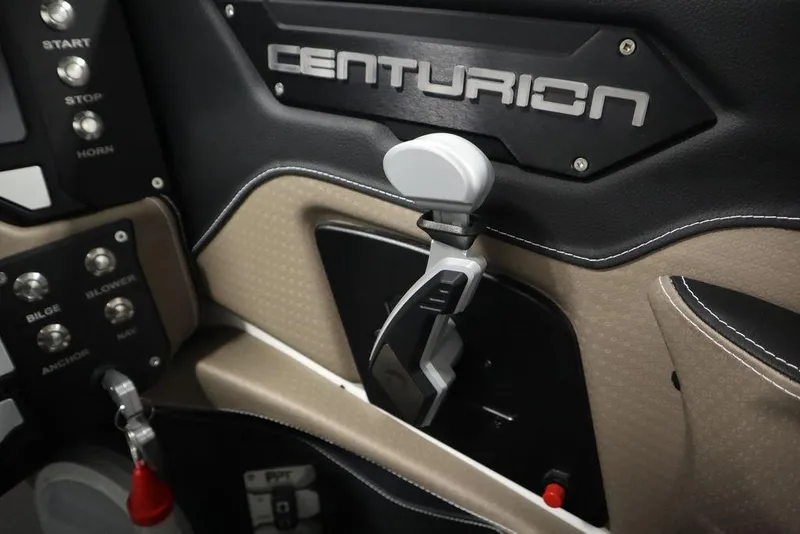 Slide: The Image of Interior of 2025 Centurion Ri245 boat, featuring control panel and throttle lever. - 24