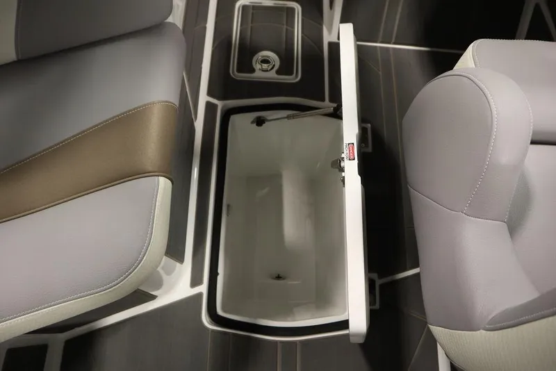 Slide: The Image of 2025 Centurion Ri245 boat interior with open storage compartment and cushioned seating. - 30