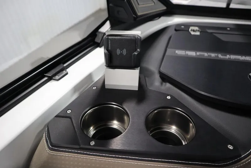 Slide: The Image of 2025 Centurion Ri245 interior with dual cup holders and wireless charging pad. - 36