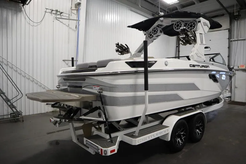 Slide: The Image of 2025 Centurion Ri245 boat on trailer in indoor storage facility. - 4