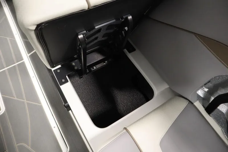 Slide: The Image of 2025 Centurion Ri245 boat storage compartment with open seat, showcasing interior design. - 41