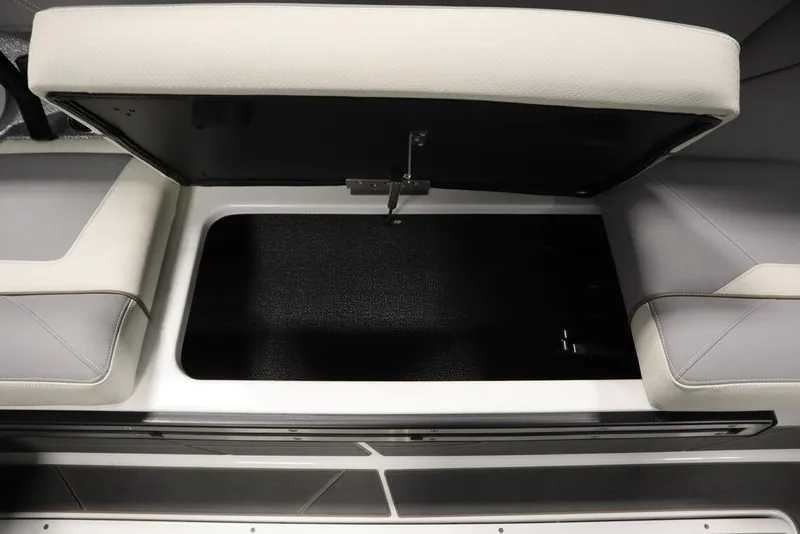 Slide: The Image of Open storage compartment in 2025 Centurion Ri245 boat with cushioned seating. - 43