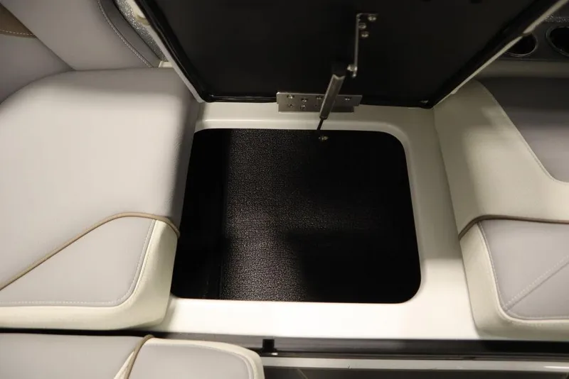 Slide: The Image of 2025 Centurion Ri245 boat interior storage compartment with open lid. - 44