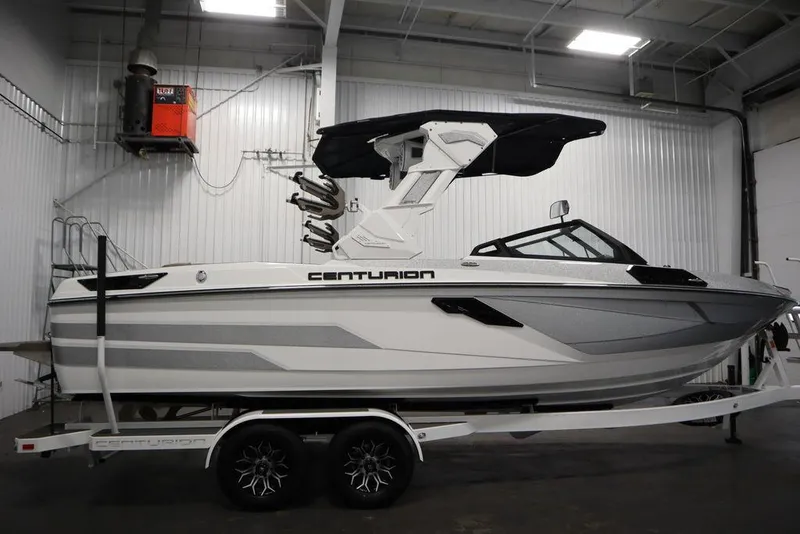 Slide: The Image of 2025 Centurion Ri245 boat in a garage, on a trailer, with sleek design and modern features. - 5