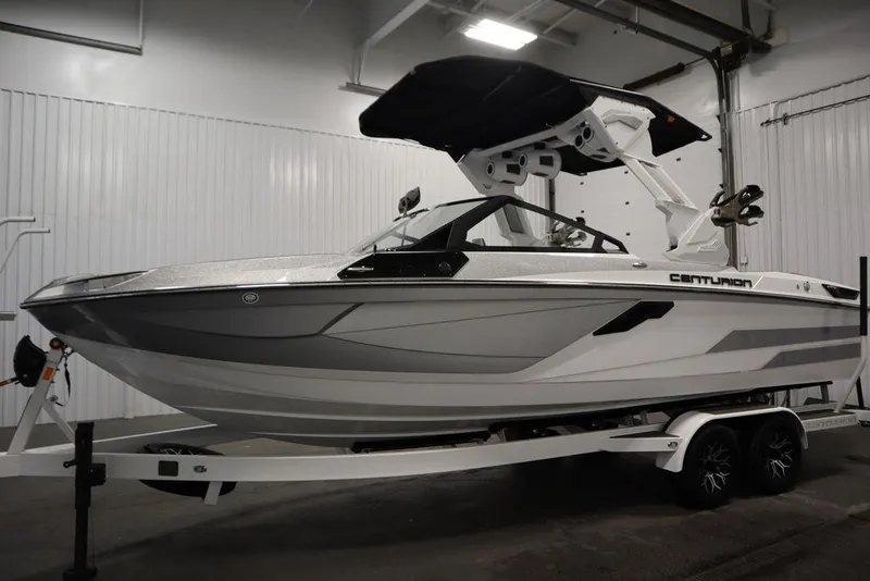 Slide: The Image of 2025 Centurion Ri245 boat on trailer in indoor storage facility. - 8