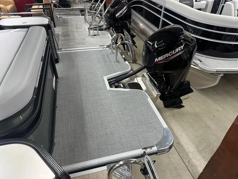 Slide: The Image of 2025 Crest Classic 220 pontoon boat with Mercury outboard motor in showroom. - 11