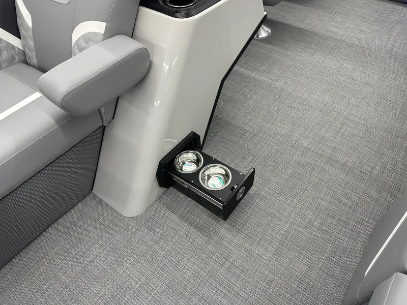 Slide: The Image of 2025 Crest Classic 220 interior with gray seating and dual cup holders. - 4