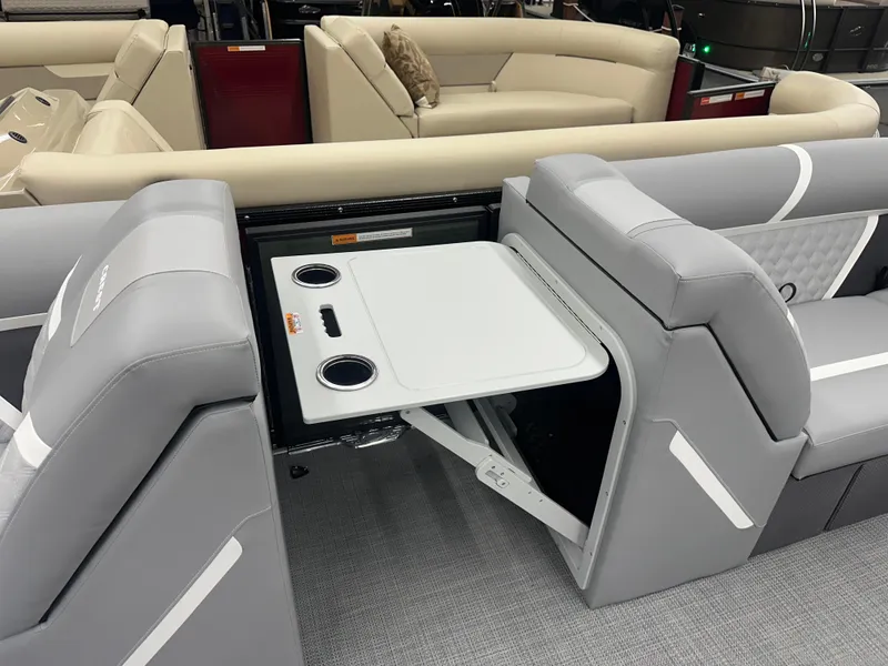 Slide: The Image of 2025 Crest Classic 220 boat interior with foldable table and cup holders. - 5