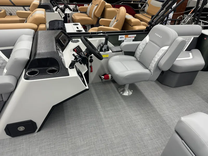 Slide: The Image of 2025 Crest Classic 220 boat interior with modern helm and comfortable seating. - 6