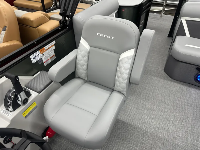 Slide: The Image of Gray captain's chair in 2025 Crest Classic 220 boat, featuring quilted accents and armrests. - 7