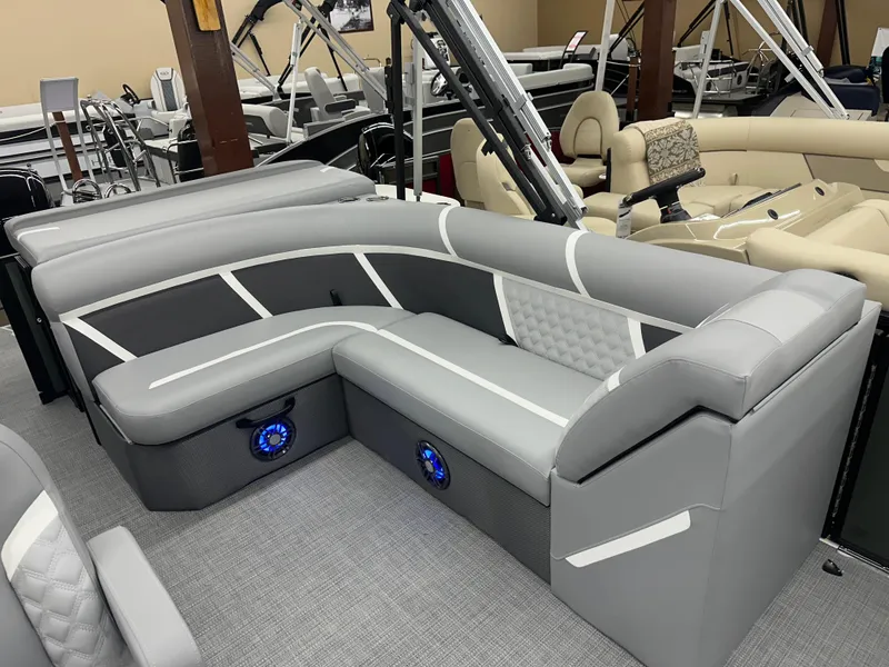 Slide: The Image of 2025 Crest Classic 220 boat interior with gray seating and blue LED speakers. - 9